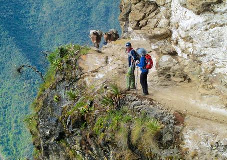 3 Choquequirao Trek - A couple of people on a hike near a cliff