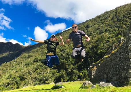 2 Inca Trail 7D - Couple jumping next to an Inca wall