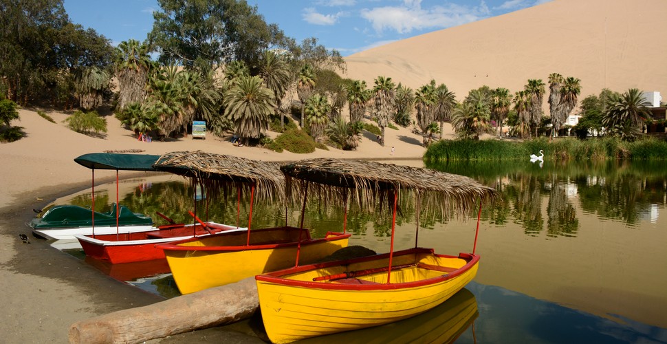 Huacachina offers some green respite in the middle of some arid rolling sand dunes. Not far from Ica, you can visit on Ica Peru tours.  This undeniably picture-perfect oasis is a natural oddity of the perfect blend of adventure activities and relaxation, which is why it welcomes a steady flow of travelers from all over the universe on their Peru vacation packages.