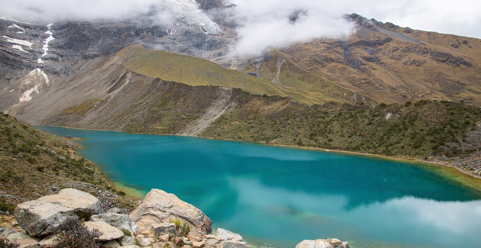 Humantay Lake (Laguna Humantay) is a shimmering turquoise jewel that enchants trekkers and photographers alike. Located at an altitude of about 4,200 meters (13,780 feet), this glacial lake is one of the highlights of the Salkantay Trek to Machu Picchu. 