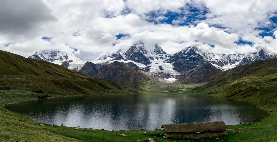 The Huayhuash mountain range in Peru is home to several stunning lakes, each with its own unique beauty and charm. This high-altitude lake Siula offers breathtaking views of the Siula Grande mountain, made famous by Joe Simpson's book "Touching the Void."