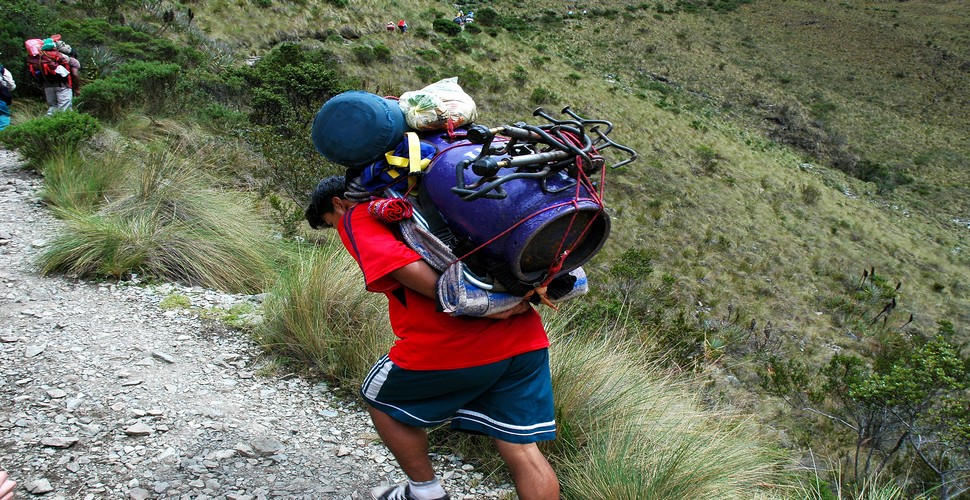 Once trekkers arrive at the campsite on their Machu Picchu Inca Trail tour, porters are responsible for setting up tents and preparing meals. They ensure that everything is in place for a comfortable and enjoyable camping experience.