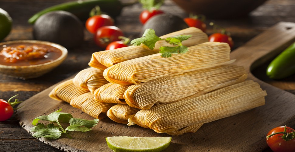 Tamales are another traditional dish enjoyed during Fiestas Patrias in Peru. They are made from corn dough that is filled with meats, cheeses, or vegetables.  Tamales are then wrapped in banana leaves or corn husks and steamed. The perfect snack on every Street corner on your vacation packages to Peru Machu Picchu. 